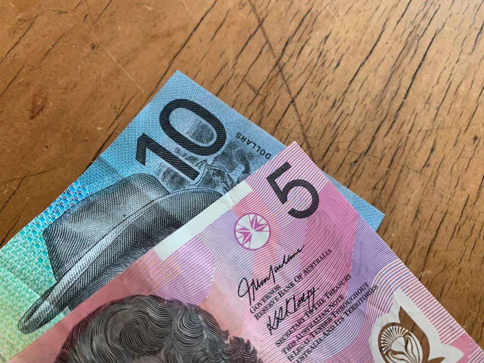 Australian dollar notes on a wooden table