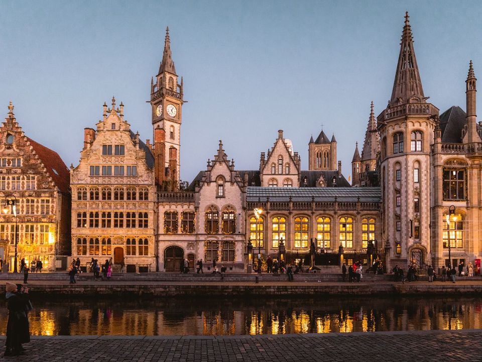 Ghent's old guild houses reflected in the canal at dusk