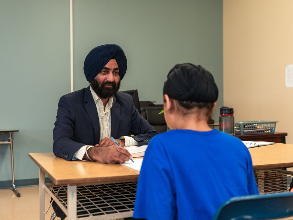 A counsellor meeting a student across a desk