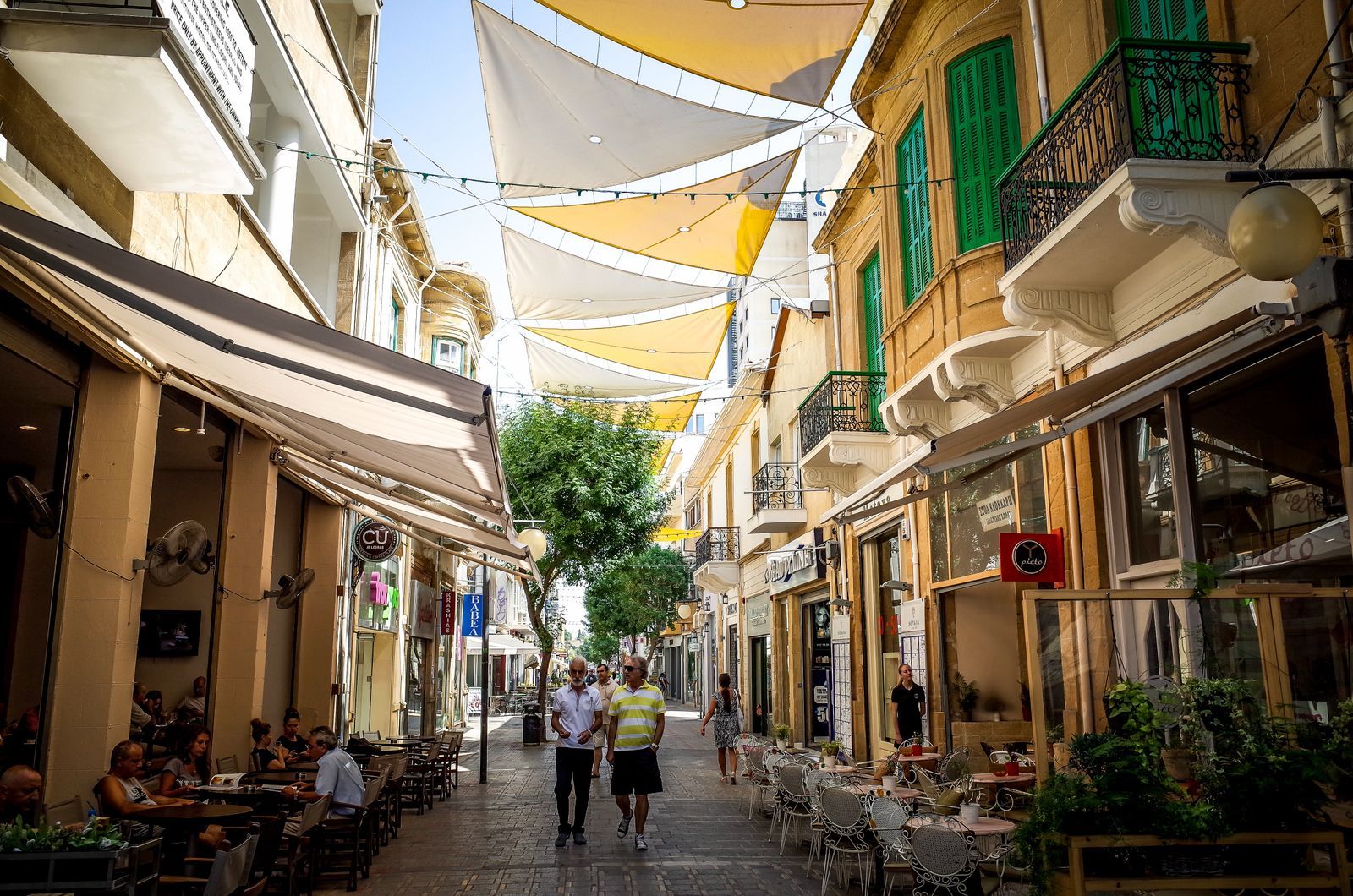 A shaded pedestrian street with cafes in Nicosia