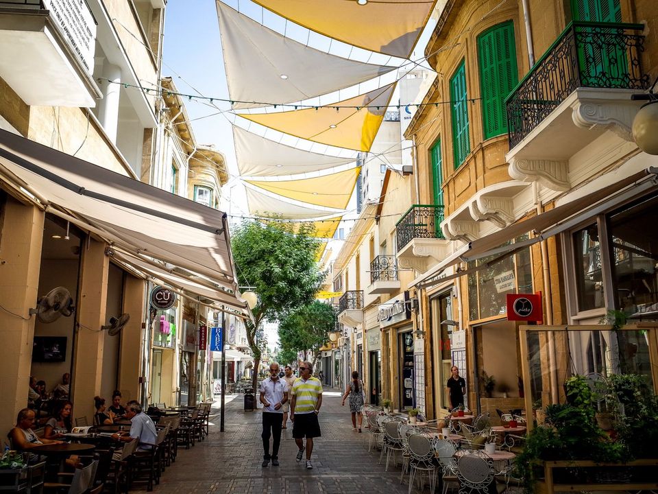 A shaded pedestrian street with cafes in Nicosia