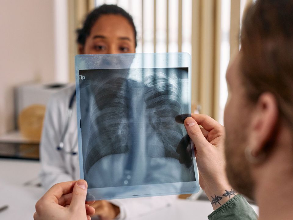 A doctor showing a chest X-ray to a patient
