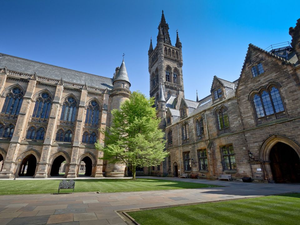 The main quadrangle of the University of Glasgow under a blue sky