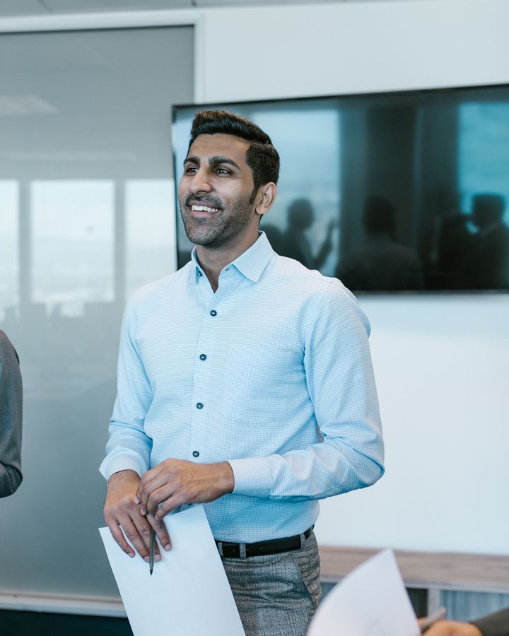 A young professional presenting a plan to his team