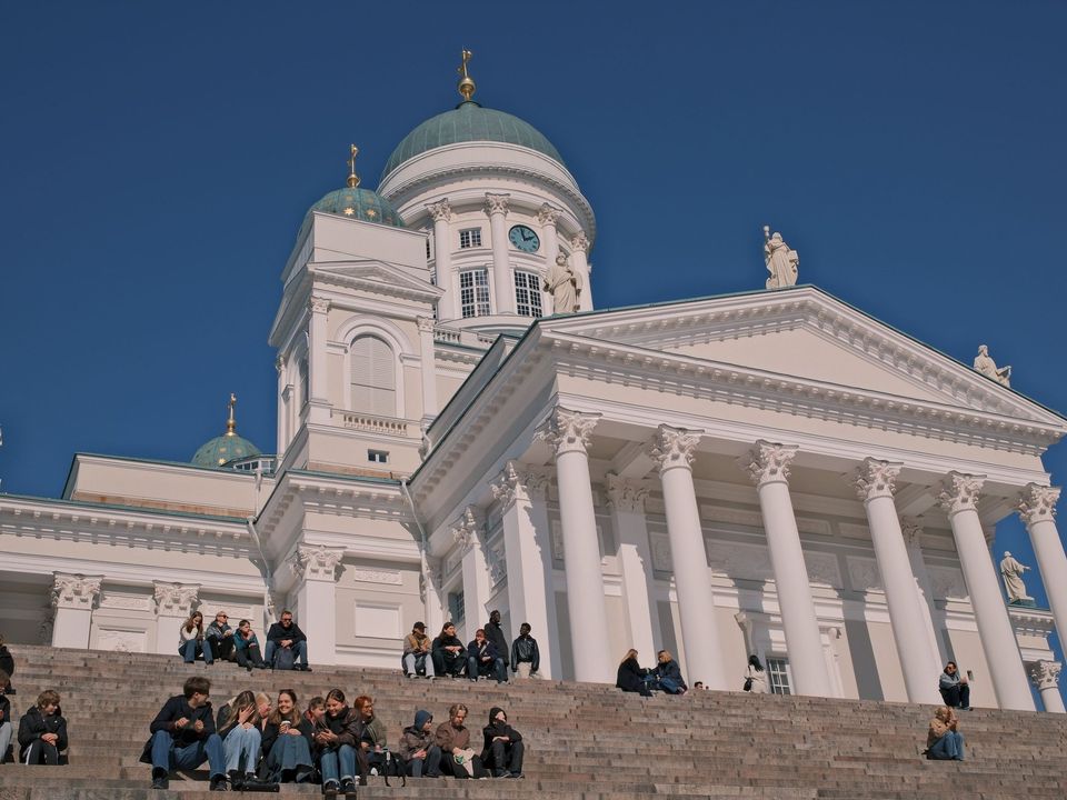 Helsinki Cathedral with people sitting on its steps