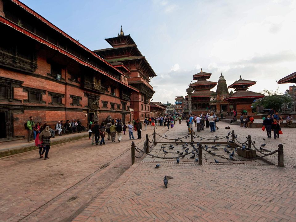Kathmandu Durbar Square in Basantapur, with people and pigeons in front of the temples