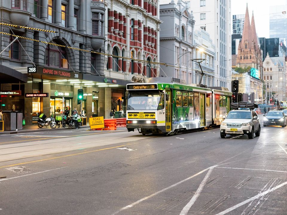 Trams and traffic on a busy Melbourne city street