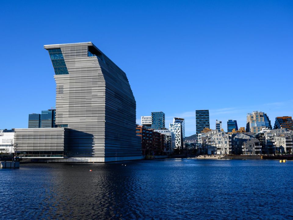 The Munch museum and Oslo's waterfront under a blue sky