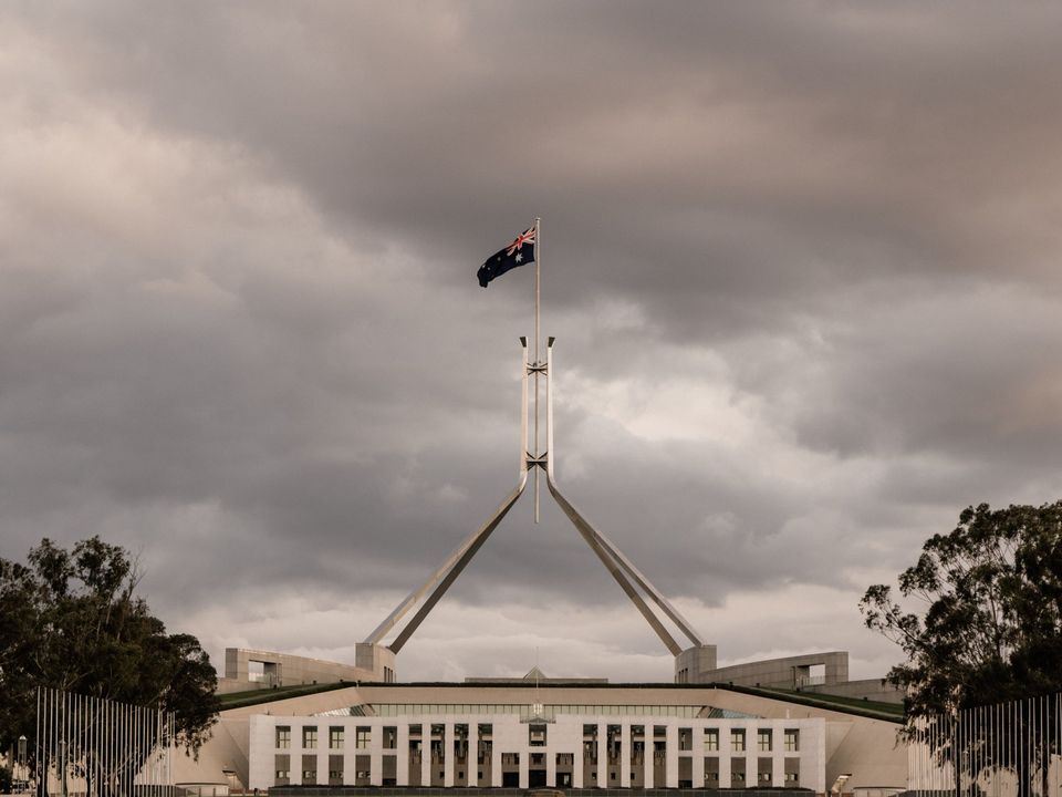Parliament House in Canberra under a cloudy sky