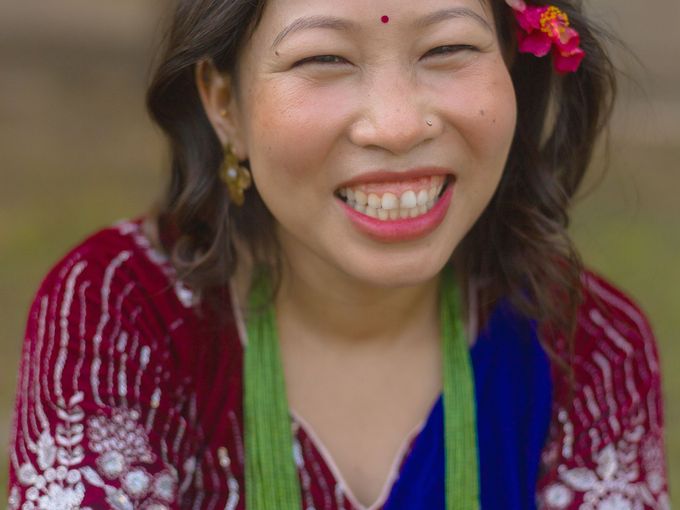 A laughing young woman with a flower in her hair