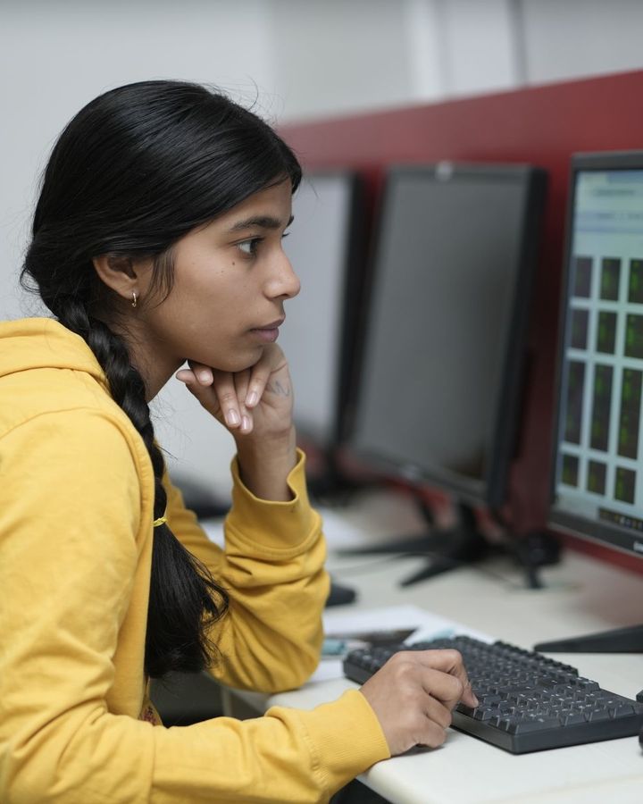 A student working on code in a university computer lab