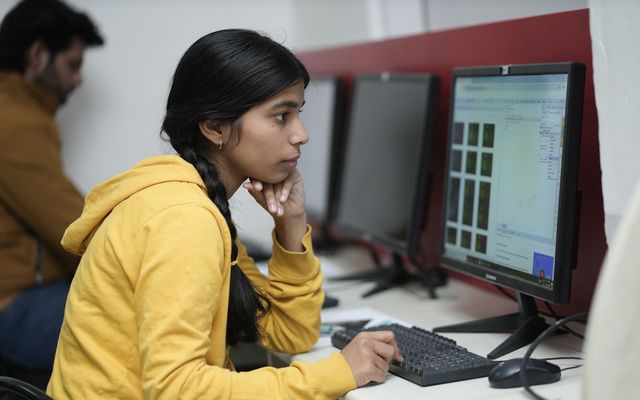 A student working on code in a university computer lab