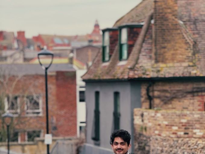 A student walking down a cobbled street in an old German town