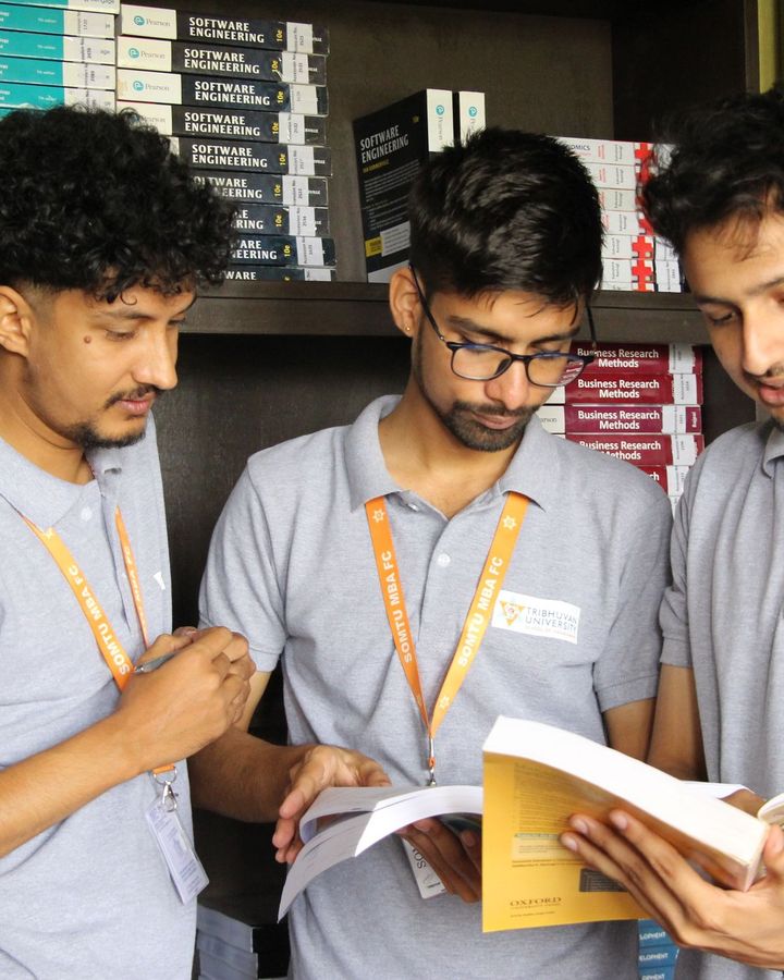 Three students reading notes together