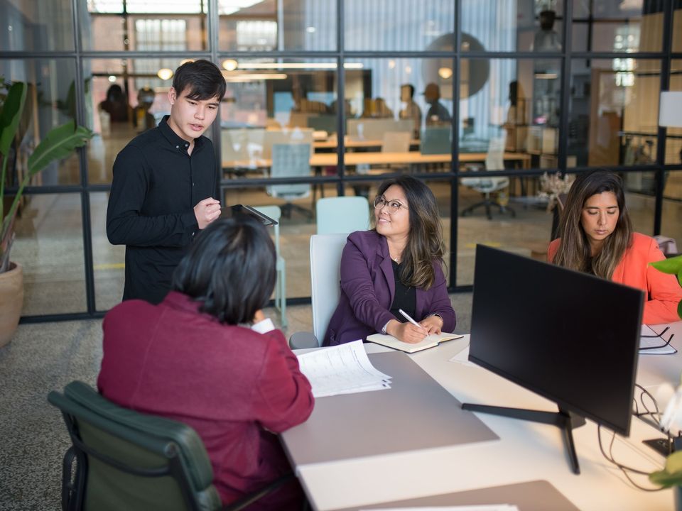 Colleagues in a meeting around a table in a modern office